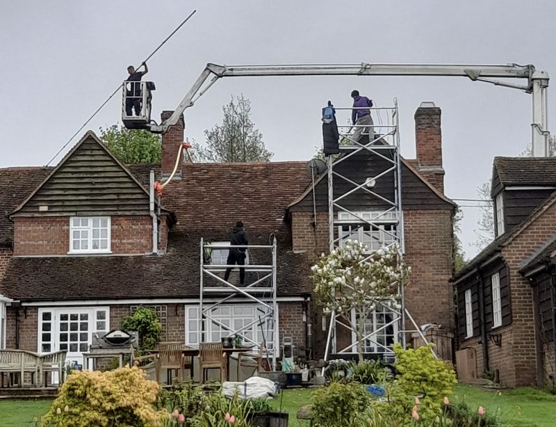 The Roof Moss Cleaners using cherry picker and scaffolding to clean roof safely and professionally in Netley, Hampshire